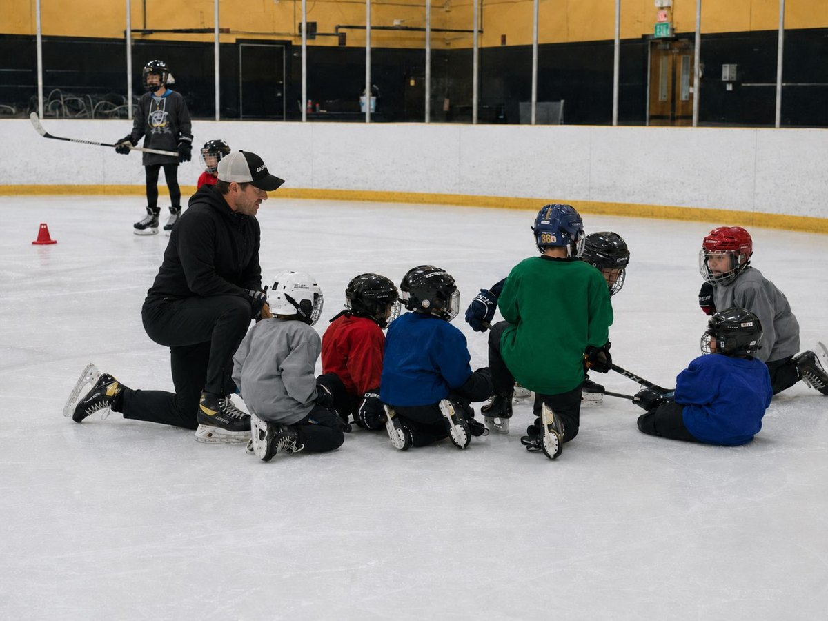 Coach guiding young hockey players during an on-ice training session.